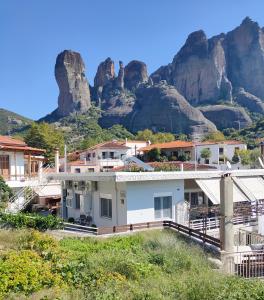 a house with a mountain in the background at Nikos, Old Kalabaka Apartment in Kalabaka