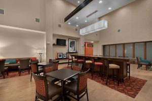 a restaurant with tables and chairs in a room at Hampton Inn & Suites Tampa Northwest/Oldsmar in Oldsmar
