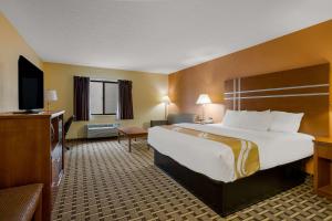 a hotel room with a large bed and a television at Quality Inn Ashland I 71 & US 250 in Ashland +22 photos