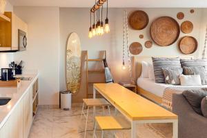 a kitchen and a living room with a bed and a table at CS Downtown Loft CSL in Cabo San Lucas