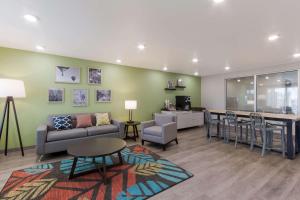 a living room with a couch and a table at WoodSpring Suites Chandler Airport in Chandler