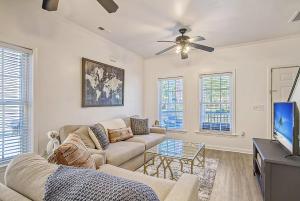 a living room with a couch and a tv at Cam's Retreat on Apple Street in Charleston