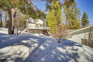 a house in the snow with trees in front of it at Paramount Paradise in Big Bear Lake