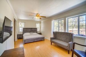 a bedroom with a bed and a chair and a ceiling fan at Paramount Paradise in Big Bear Lake