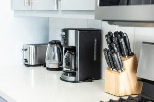 a kitchen counter with a coffee maker and utensils at 8 Beds Home with 4 Car Parking Space - Near DTLB in Long Beach +42 photos