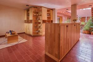 a large room with wooden cabinets and a table at Hotel Materia in Oaxaca City