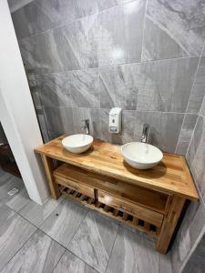 a bathroom with two sinks on a wooden counter at Don Enrique Bar&Hostel in San Gregorio