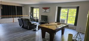 una sala de estar con mesa de ping pong. en Southford spacious apartment - Southbury, Connecticut, en Southbury