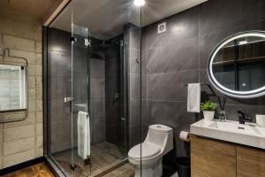 a bathroom with a shower and a toilet and a sink at Downtown Loft by ULIV in Tijuana