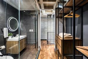 a bathroom with a sink and a mirror at Downtown Loft by ULIV in Tijuana +11 photos