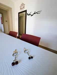 a pair of earrings sitting on top of a bed at I Due Ciliegi in Abbadia San Salvatore