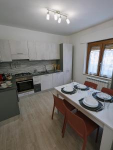 a kitchen with a table and chairs in a kitchen at I Due Ciliegi in Abbadia San Salvatore