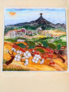 une peinture d'un signe avec un tas de cerises dans l'établissement I Due Ciliegi, à Abbadia San Salvatore