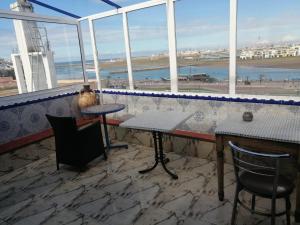 a bar with a view of the beach from a window at Dar mahfoud in Rabat