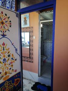 a bathroom with a mirror and a toilet in a room at Dar mahfoud in Rabat