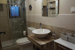 a bathroom with a sink and a toilet and a shower at El Colibrí de Taraza in San Pedro de Latarce +36 photos