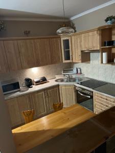 a kitchen with wooden cabinets and a wooden counter top at Apartament Familijny Beskidzki in Ustroń