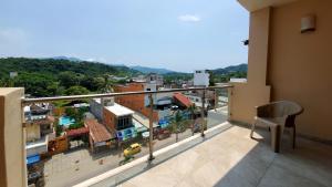 a balcony with a view of a city at Aurora Resort in Rincon de Guayabitos