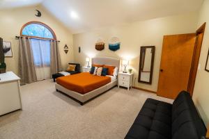 a bedroom with a bed and a couch in it at Harmony Hill Stylish 4bd Mountain Retreat, Hot Tub, Games in Bushkill