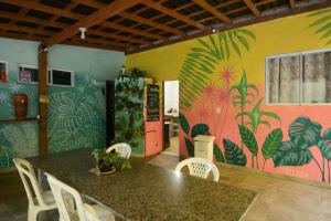 a dining room with a table and a colorful wall at Floripa Camping e Hostel Florianopolis SC in Florianópolis