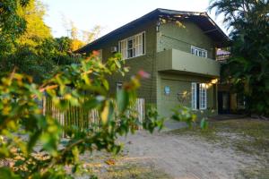 a house with a fence in front of it at Floripa Camping e Hostel Florianopolis SC in Florianópolis