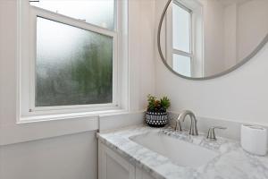 a white bathroom with a sink and a mirror at Unit 4: Large fully furnished 1 bedroom in Billings