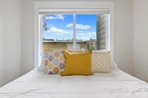a bed with pillows and a window in a room at Unit 4: Large fully furnished 1 bedroom in Billings