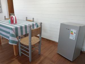 a table and a refrigerator in a room at Las Nativas de Areco in San Antonio de Areco