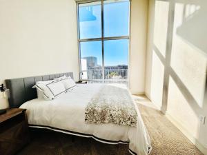 a bedroom with a bed and a large window at Downtown Oasis Heart Of Austin in Austin