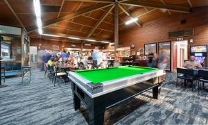 a pool table in a room with people in a restaurant at Leigh Creek Outback Resort in Leigh Creek
