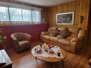 a living room with a couch and a coffee table at Charming - 2 bedrooms basemnt, 1 full bath & rec room in Kamloops