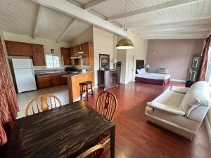 a living room and kitchen with a couch and a table at Town and Country Inn in Santa Maria