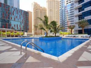 a swimming pool in a city with tall buildings at Key View - Bay Central West in Dubai