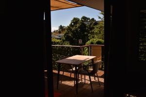 a table and a chair on a balcony at Fare O Mape in Faaa