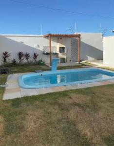 a small swimming pool in the backyard of a house at Casa Amar Cumbuco in Cumbuco