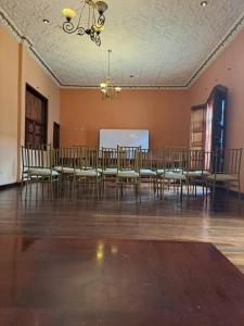 a large room with a table and chairs in it at Hotel Coronel in Cuenca