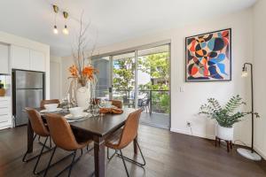 a kitchen and dining room with a table and chairs at Avon Lane @ Gilberton in Adelaide