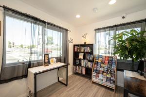 a room with a book shelf and a table with books at Unik Motel in Harbor City +11 photos