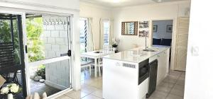 een keuken met een wastafel en een aanrecht bij Mango Tree Holiday Apartments in Port Douglas