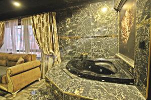 a bathroom with a tub with a marble counter at Elegant House Otel in Ankara