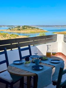 a table with two glasses of wine on a balcony at Estrela Villas in Estrela