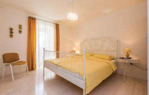a bedroom with a bed with a yellow bedspread at Apartments with parking space Crikvenica - 14631 in Crikvenica