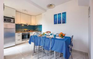 a kitchen with a table with blue table cloth at Apartments with parking space Crikvenica - 14631 in Crikvenica