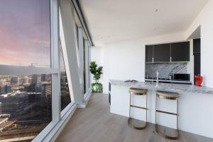 a kitchen with a view of a city at Iconic High-view Oasis between Docklands and CBD in Melbourne