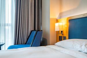 Ένα ή περισσότερα κρεβάτια σε δωμάτιο στο Centum Business Hotel