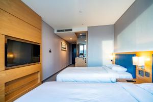 Ένα ή περισσότερα κρεβάτια σε δωμάτιο στο Centum Business Hotel