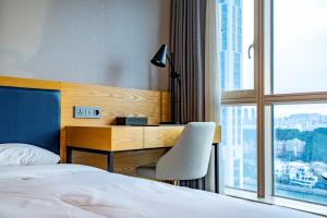 Ένα ή περισσότερα κρεβάτια σε δωμάτιο στο Centum Business Hotel