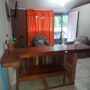 een houten bureau in een kamer met een raam bij Departamento Minae in Puerto Jiménez