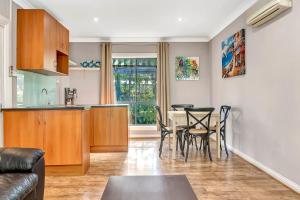 a kitchen and dining room with a table and chairs at Stump Hill Estate - A Unique Stay with Mini Golf in McLaren Vale
