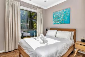 a bedroom with a bed and a large window at Stump Hill Estate - A Unique Stay with Mini Golf in McLaren Vale